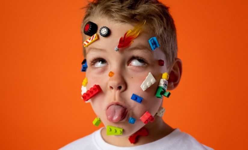 Little boy with lego stuck to his face